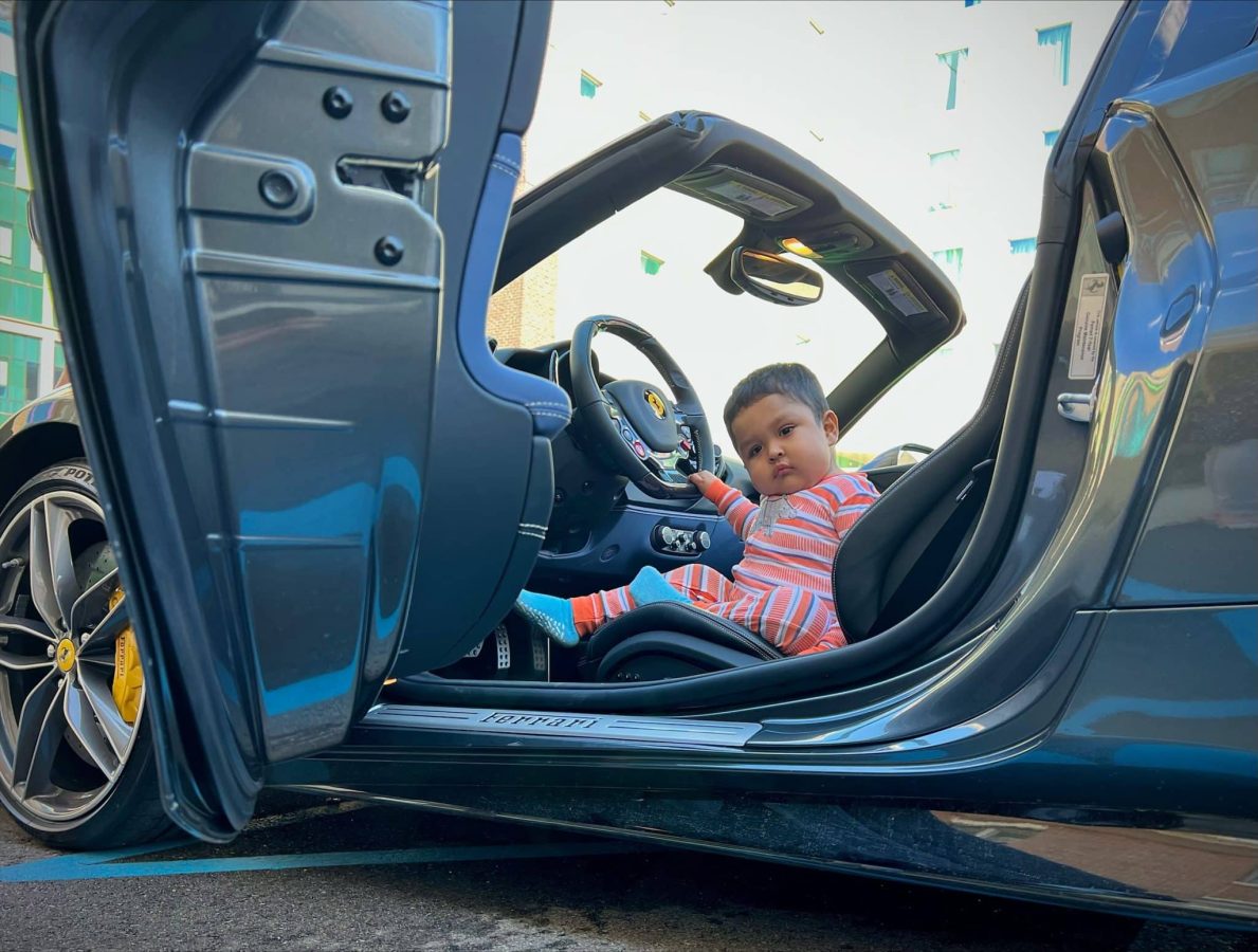 Image from Moments of Joy - A child in the driver seat of a car